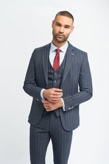 Man wearing a gray pinstripe suit with a red tie on a white background